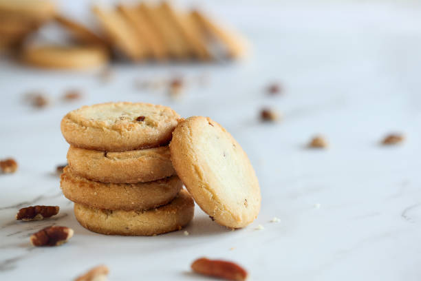 Stack of Pecan Sandies Cookies Stack of pecan sandies cookies. Selective focus with blurred foreground and background. sable stock pictures, royalty-free photos & images