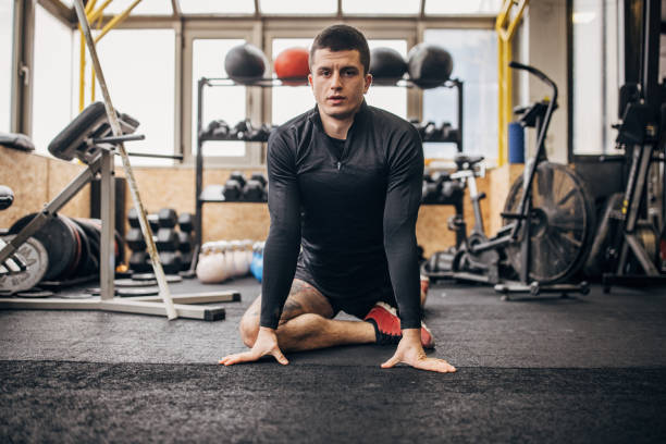 istock Fit man exercising in gym 1366575470