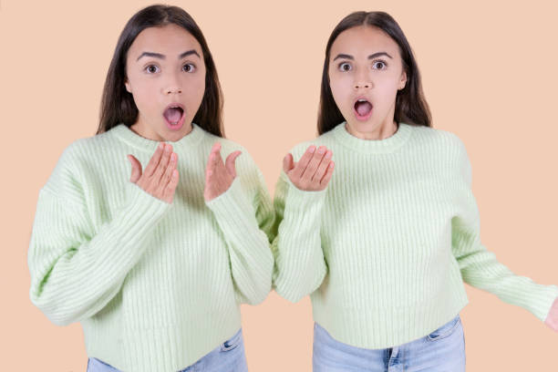 istock twin sisters frightened expression fear, studio background 1366575626