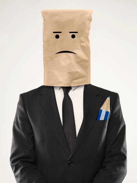 Sad businessman with paper bag over his head