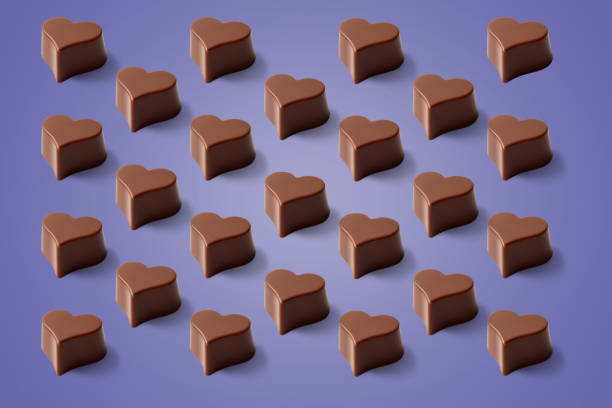 istock Valentines day lilac background of chocolate heart pattern. 1366579099