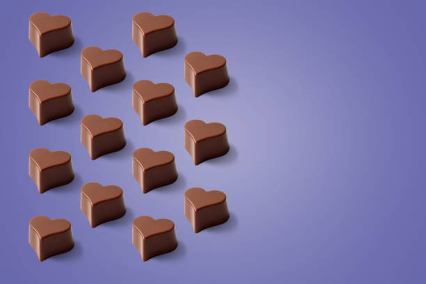 istock Valentines day lilac background of chocolate heart pattern. 1366579103