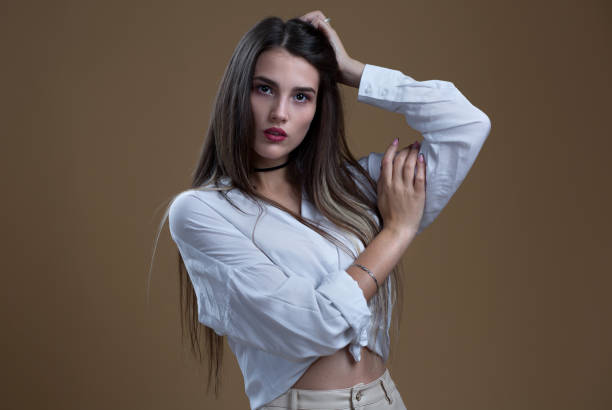 istock A girl in a white blouse on a beige background 1366579253