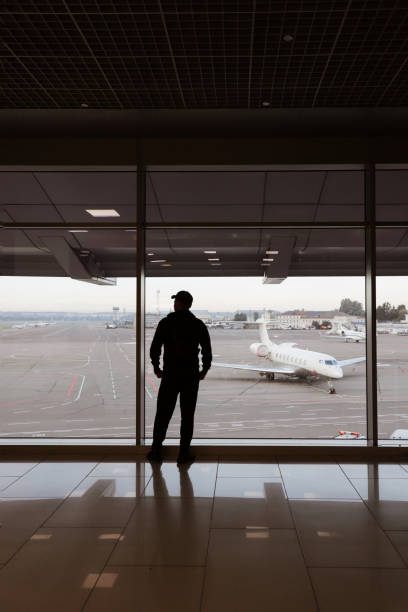 istock young man in airport near window 1366579434