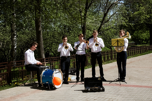 Belarus, Novopolotsk  - july 17, 2018: Musician guys in a summer park play trumpets