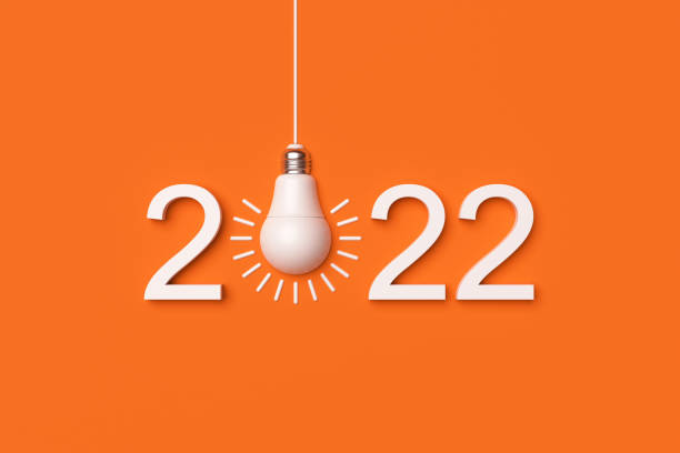 istock 2022 and white led lamp on orange background. Idea concept. 1366579856