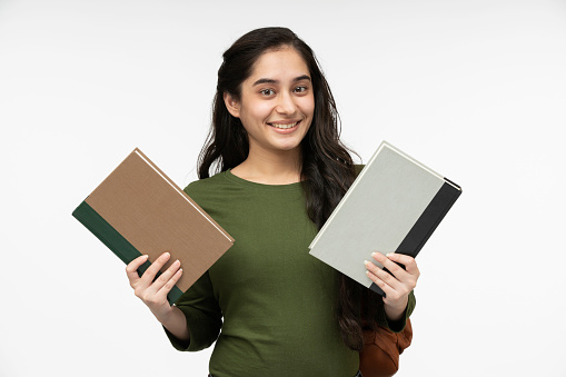 Young happy student with books isolated on white background.