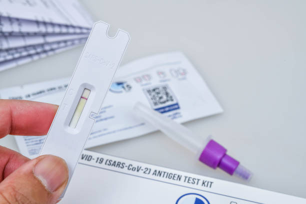 istock Hand holding Covid-19 negative test result with SARS-CoV-2 Rapid antigen test kit (ATK) 1366581887