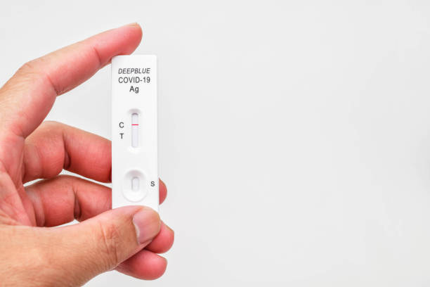 istock Hand holding Covid-19 negative test result with SARS-CoV-2 Rapid antigen test kit (ATK) 1366581943