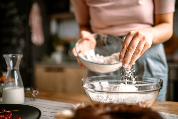 istock Woman adding a flour in cake batter for better structure 1366582591