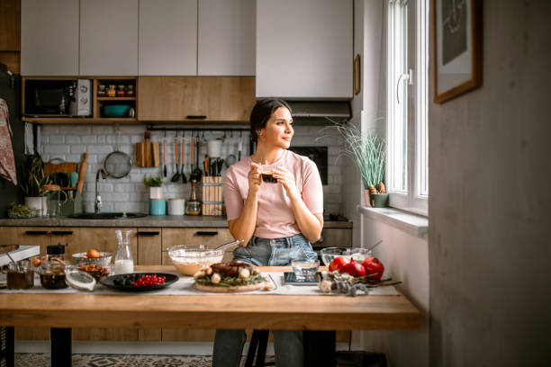 istock Woman taking a coffee break in the kitchen 1366582610