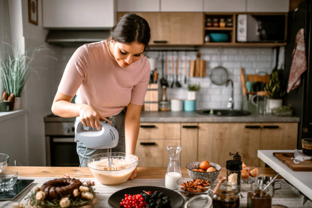 istock Mixing cake batter with electric mixer in the kitchen 1366582623