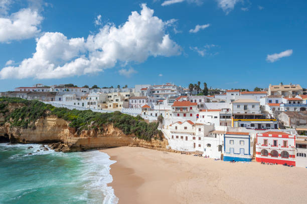 Townscape of Carvoeiro in the Algarve with beach and rocky coastline Cityscape of Carvoeiro in the Algarve in Portugal with beach and rocky coast beautiful beach in carvoeiro algarve portugal stock pictures, royalty-free photos & images