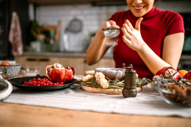 istock Woman icing powdered sugar on baked cake 1366583273