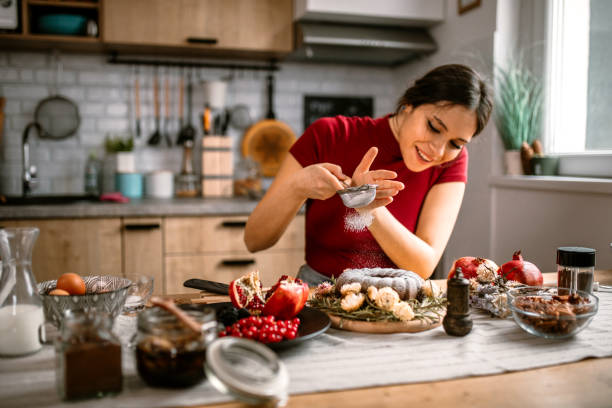 istock Woman icing powdered sugar on baked cake 1366583275