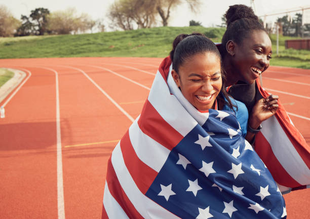 istock Shot of two female athletes hugging 1366583437
