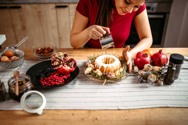 istock Woman decorating cake pouring white chocolate sauce over cake 1366583668