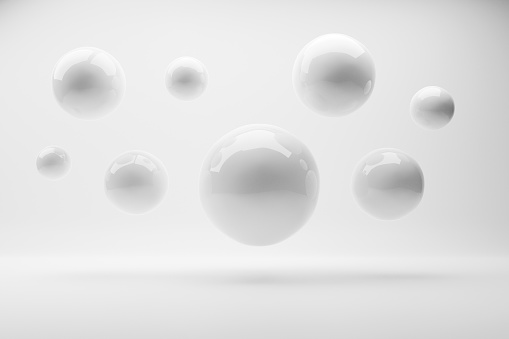 White spheres flying on the white background. Abstract white background