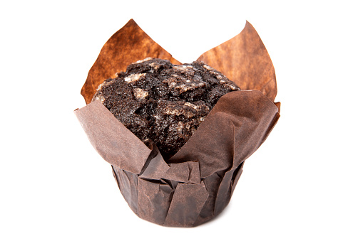 A delicious chocolate muffin isolated on a white background.
