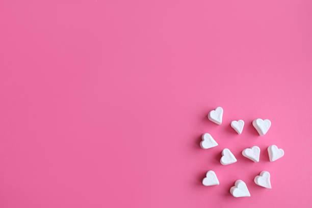 istock Minimalist Valentine's day. White marshmallow hearts on pink pastel background. Composition for Valentins Day, Mother's Day, March 8 or Women's Day. 1366586245