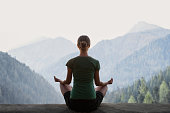 Woman practicing yoga in a mountains. Meditation and harmony concept