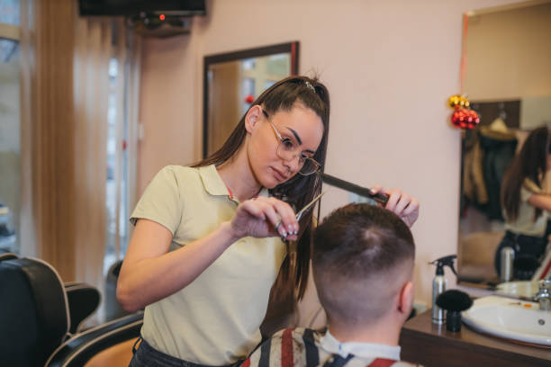 istock Young man having a haircut at a barbershop 1366586549