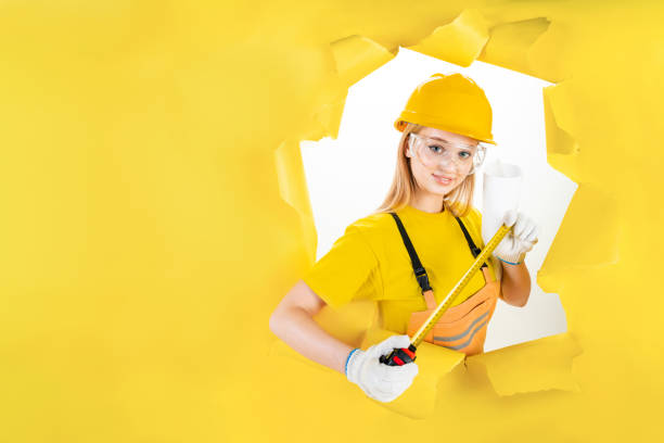 istock Builder engineer is holding tape-line for measure. 1366587814