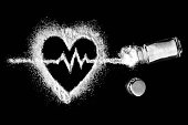 Heart, cardiogram, salt and salt shaker on black background