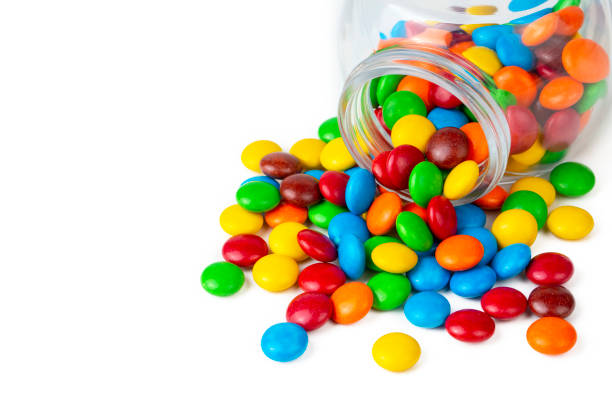 istock Colorful chocolate buttons on a white background 1366589265