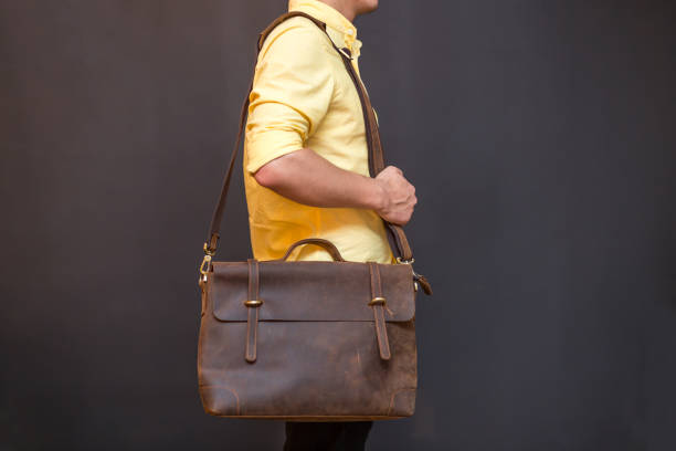 istock Man with brown leather messenger bag on gray background 1366589630