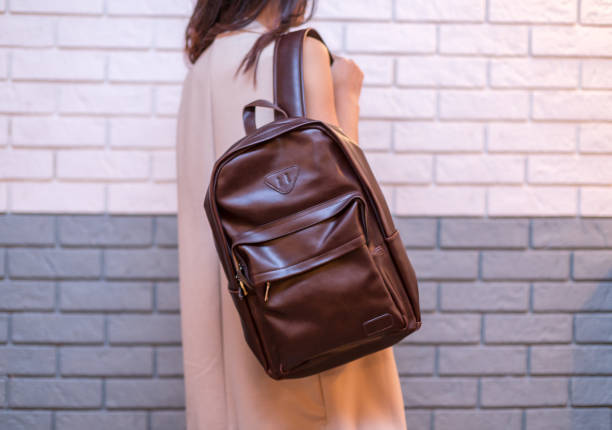 istock Woman holding brown leather backpack in the hand 1366589832