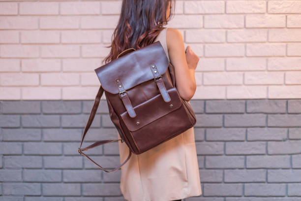 istock Woman holding brown leather backpack in the hand 1366589911