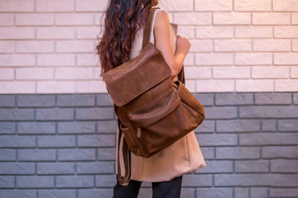 istock Woman holding brown leather backpack in the hand 1366589972