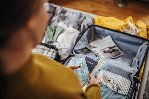 istock Woman packing things in the suitcases 1366593828