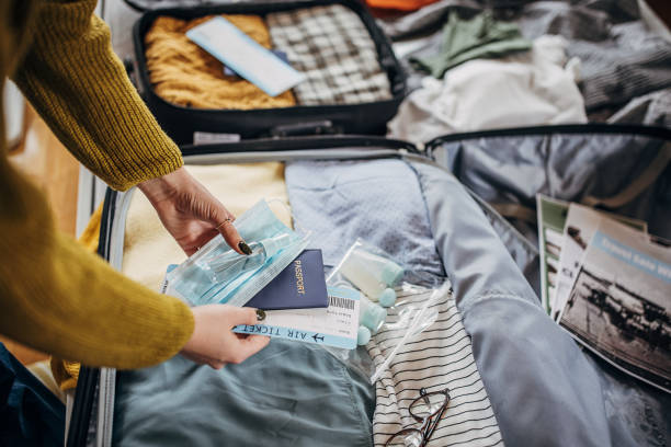 istock Woman packing things in the suitcases 1366593851