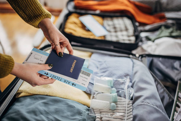 istock Woman packing things in the suitcases 1366593923