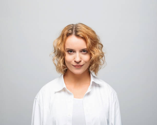 istock Cheerful young woman in white shirt 1366594994