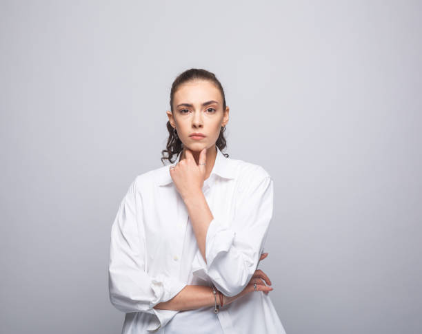 istock Confident young woman in white shirt 1366595317