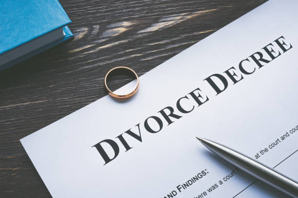 istock Divorce degree for signing and a wedding ring. 1366595496