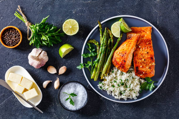istock fried salmon fish fillet with rice and asparagus 1366595530
