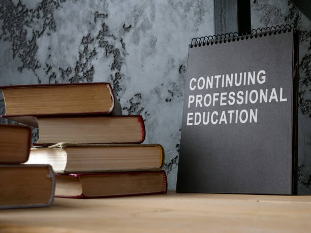 istock Continuing professional education on the black notepad and books. 1366595550
