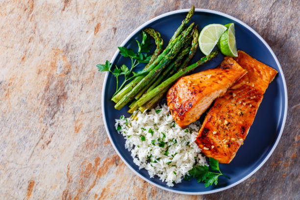 istock fried salmon fish fillet with rice and asparagus 1366596084