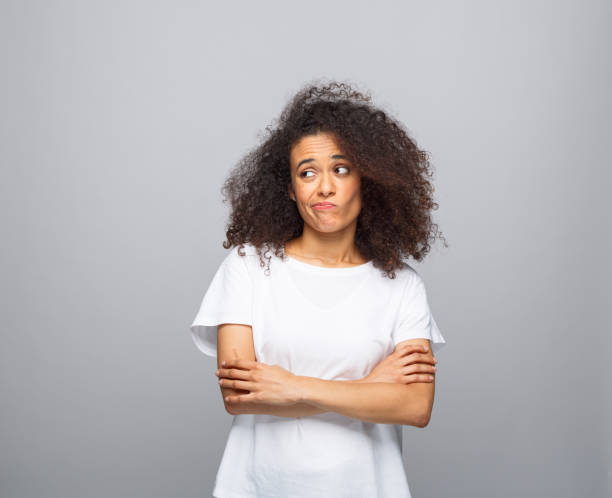 istock Confused young woman in white t-shirt 1366596231