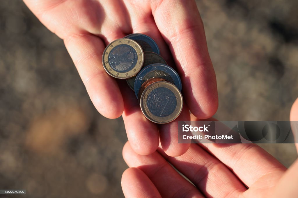 commercial, money or financial exchange, people sharing money concepts, abstract blurred background close up view of the hands of two caucasian men sharing euro coins Adult Stock Photo