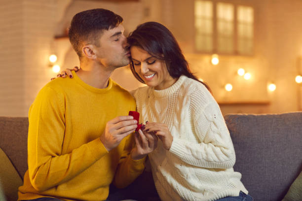 istock Young smiling woman getting proposal with ring from her boyfriend during Valentines day celebration 1366596943