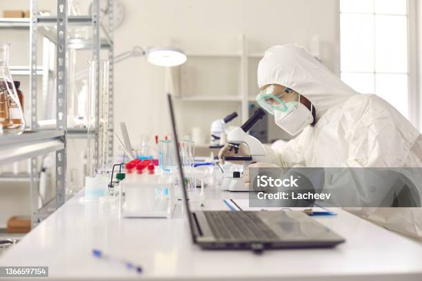Unrecognizable Scientist Pharmacologist In Protective Uniform At Laboratory Stock Photo - Download Image Now