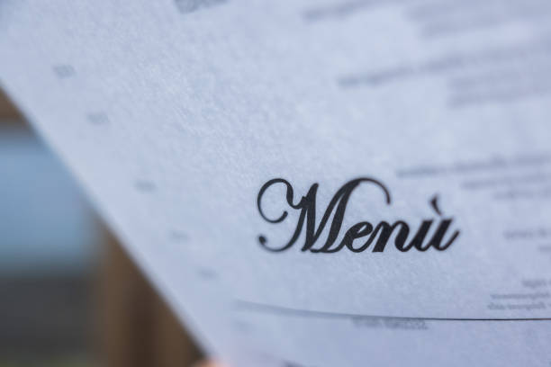white paper with black menu writing, selective focus, going to or take an order at the restaurant concept