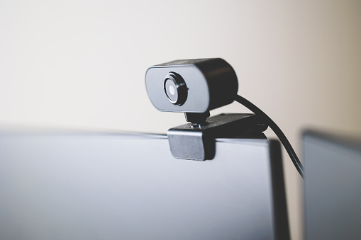 close up view on a black webcam attached to a desktop computer
