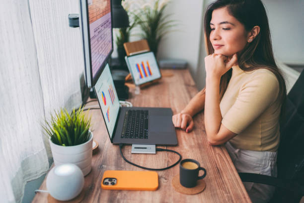 istock Woman working at home talks to virtual assistant 1366598546