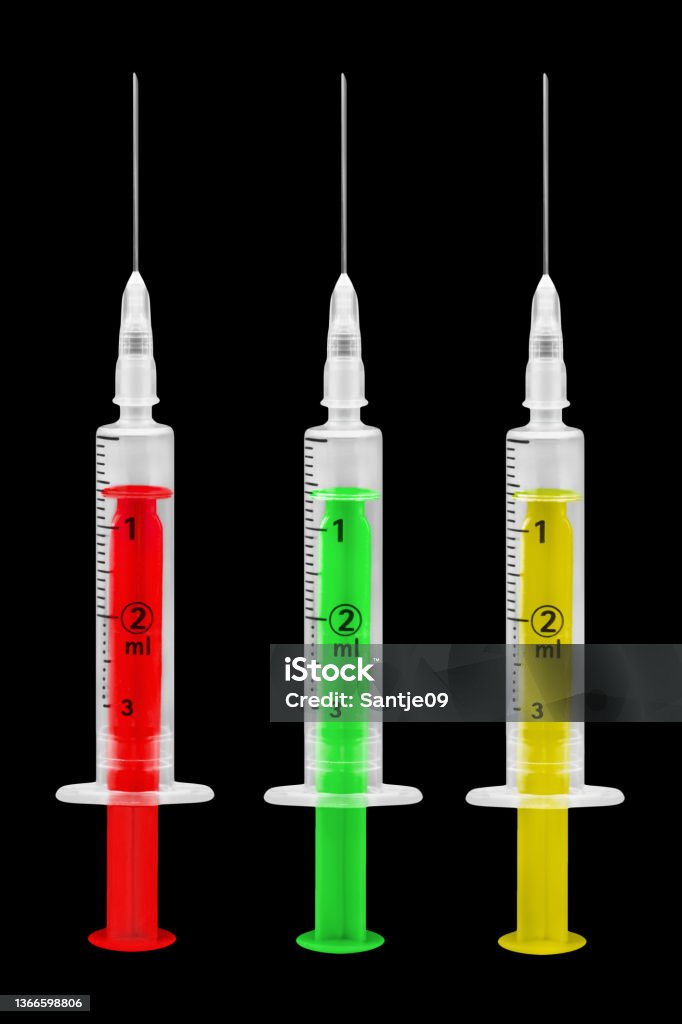 Corona vaccination and 3 injections red green yellow on black background Ampelmännchen Stock Photo